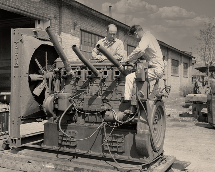 Historic image of students working on machinery