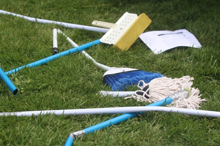 Brooms and rule sheets on the ground