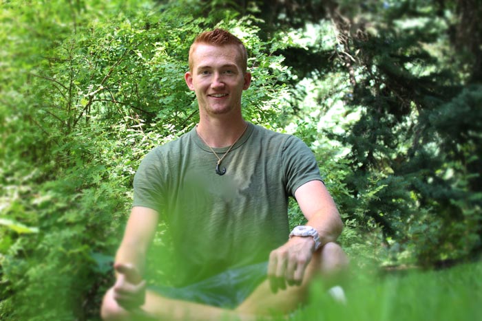 Man sitting among trees